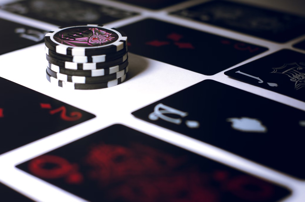 Stack of poker chips on a table with playing cards